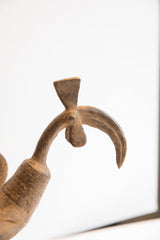 Detail of the vintage bird casting, showing its curved beak and axe-like crest.