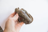 Vintage African monkey figurine viewed from above, highlighting its rustic, aged patina.