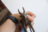 Detailed view of a vintage antelope sculpture's head showing its handmade texture.