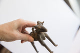 Vintage African ram sculpture with an aged finish held in hand to show scale.