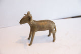 Side view of the vintage African ram sculpture with a textured back and aged metal finish.