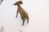 Rear view of a handmade African ram sculpture showing the textured spine detail.