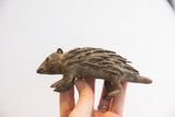 Vintage African porcupine sculpture held in hand to show its full profile and scale.