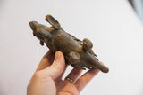 Bottom view of the vintage porcupine sculpture showing its handmade form and feet.