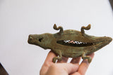 Angled view showing the hollow criss-cross body and textured head of the alligator sculpture.