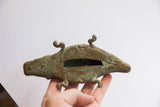 Aged patina and ribbed texture on a hollow-bodied vintage alligator sculpture.