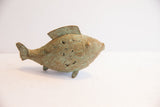 Vintage African fish casting highlighting its etched surface and aged green patina from the side.