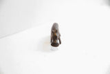 High-angle view focusing on the head and snout of the dark patina hippo figurine.