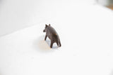 Rear view of the handmade hippo figurine showing its rounded back and legs.