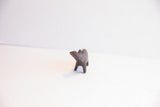Three-quarter view of a small, handmade African hippo with a dark patina.