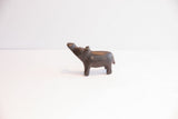 Side view of a handmade African hippo figurine with its head tilted up.