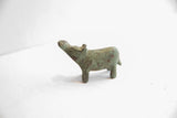 Side profile of a vintage African hippo sculpture with an oxidized green patina.