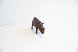 Front view of the vintage African rhino figurine showing its carved horn and dark patina.