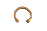Antique African geometric cuff bracelet with a warm, aged patina and ridged details.
