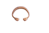 Antique African copper alloy cuff bracelet with geometric etchings and an aged patina.