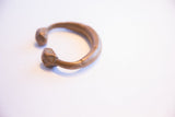 Full profile of the antique African copper alloy cuff showing its geometric ends.