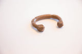 Angled view of the antique African copper cuff with hand-stamped geometric ends.