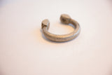 Detailed view of an antique African aluminum cuff's texture and punched dot pattern.