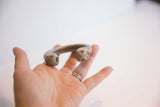 Antique African aluminum cuff bracelet held in a hand for scale.