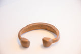 View of the antique copper snake cuff's open interior and solid, rounded ends.