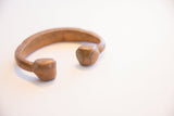 Angled view of the antique copper cuff's open design and hand-worked ends.
