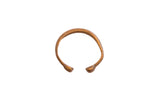 A handcrafted antique African snake cuff bracelet with a warm, textured bronze patina.
