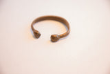 Angled view of the antique African cuff showing its open shape and patina.