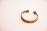 The opening of the antique African cuff bracelet highlighting its hand-shaped terminals.
