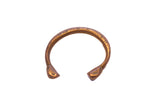 Handmade antique African snake cuff bracelet with etched markings and a warm metal patina.