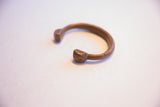 Angled profile of the antique African cuff, showing its curved form and unique terminals.