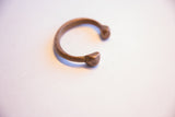 Profile view of the antique African snake cuff highlighting its C-shape and patina.