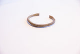 The simple, open form and time-softened patina of a vintage African cuff.