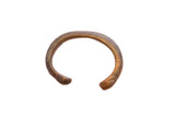 Antique African snake cuff bracelet with a textured scale-like surface and warm patina.