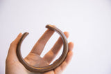 The substantial, smooth form of the antique African snake cuff shown to scale.