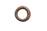 Round antique African bracelet with a textured, warm bronze finish showing its interlocking seam.
