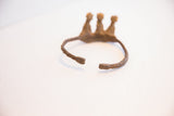 The open ends of the rustic Baole Dogon cuff bracelet, showing a deep, time-softened patina.