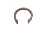 Collectible antique African manilla cuff bracelet with deep metal patina and flared ends.