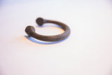 Aged surface texture and deep patina of this antique African Manilla cuff.