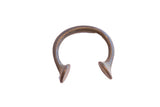 Antique African Manilla cuff bracelet with a C-shape body and dark, time-softened patina.