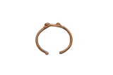 Vintage African cricket cuff bracelet handcrafted from brassy metal with a natural patina.