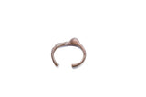 A collectible vintage African cuff bracelet with a textured, abstract metal design.