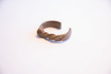 Side profile of the vintage African cuff highlights its twisted design.