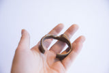 Side profile of the vintage African cuff showing its organic, abstract shape and aged patina.