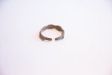 The open cuff of the vintage African bracelet showing its aged patina.