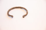 Angled view of the vintage African twist cuff highlighting its rustic texture.