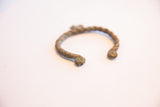 Side profile of the oxidized African cuff showing its twisted texture and form.