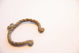 The handcrafted chameleon figure on the twisted, oxidized African cuff.