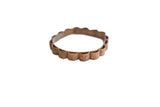 Vintage African bracelet with a scalloped edge and an embossed floral design patina.