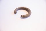 Angled view of the vintage African cuff showing its ribbed texture and patina.