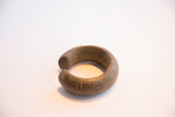 Side view of the antique African cuff showing its open shape and substantial thickness.